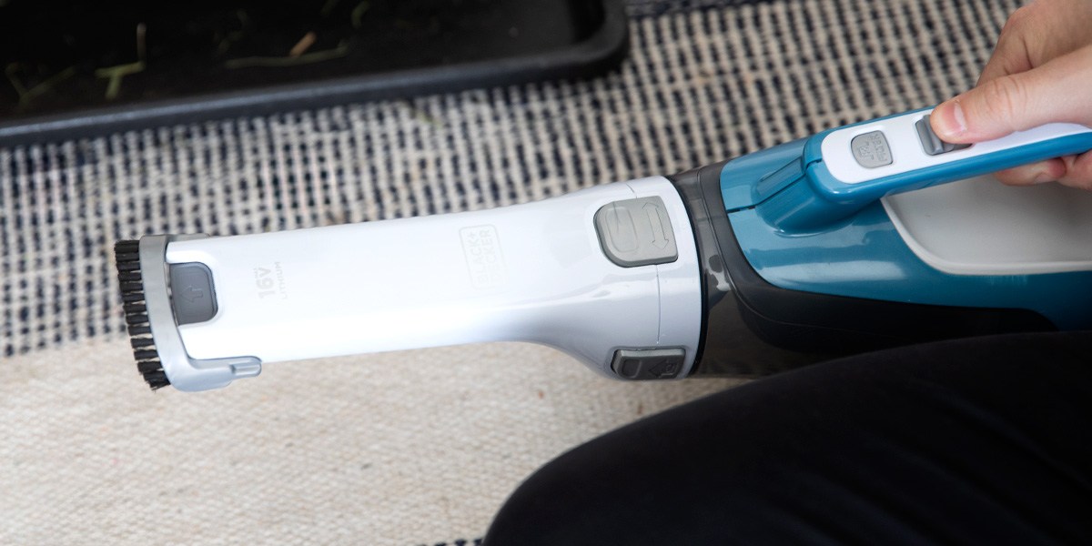 Person using Black and Decker Dustbuster AdvancedClean Cordless Handheld Vacuum