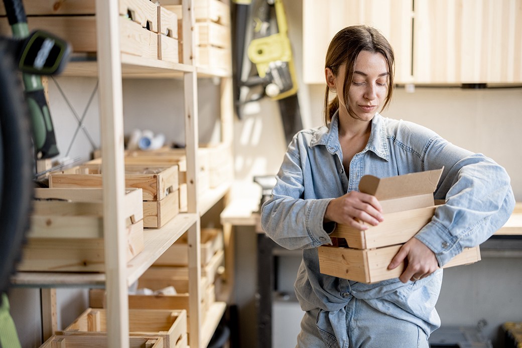 Woman placing items on shelves in garage