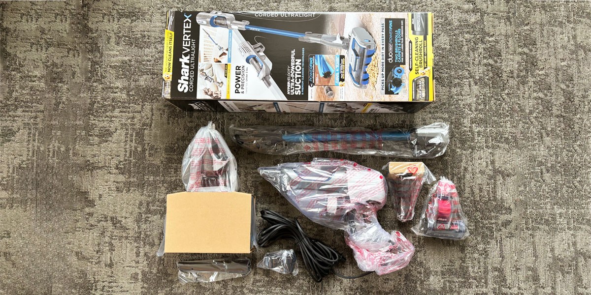 Shark Vertex HZ2002 Ultralight Corded Stick Vacuum and accessories next to product packaging Shark Vertex HZ2002 Ultralight Corded Stick Vacuum and accessories next to product packaging