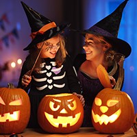 a woman and a young girl in witch costumes
