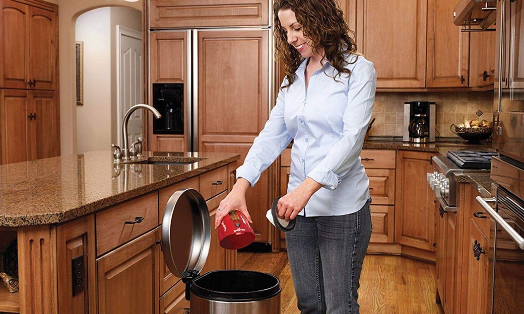 a woman cleaning a vacuum's filter