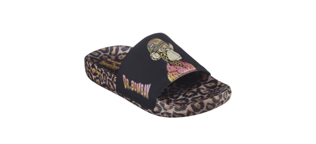 cheetah print slide sandals with a black upper portion that has a cartoon image of Dr. Bombay on the top and the words &quot;Dr. Bombay&quot; on the side.